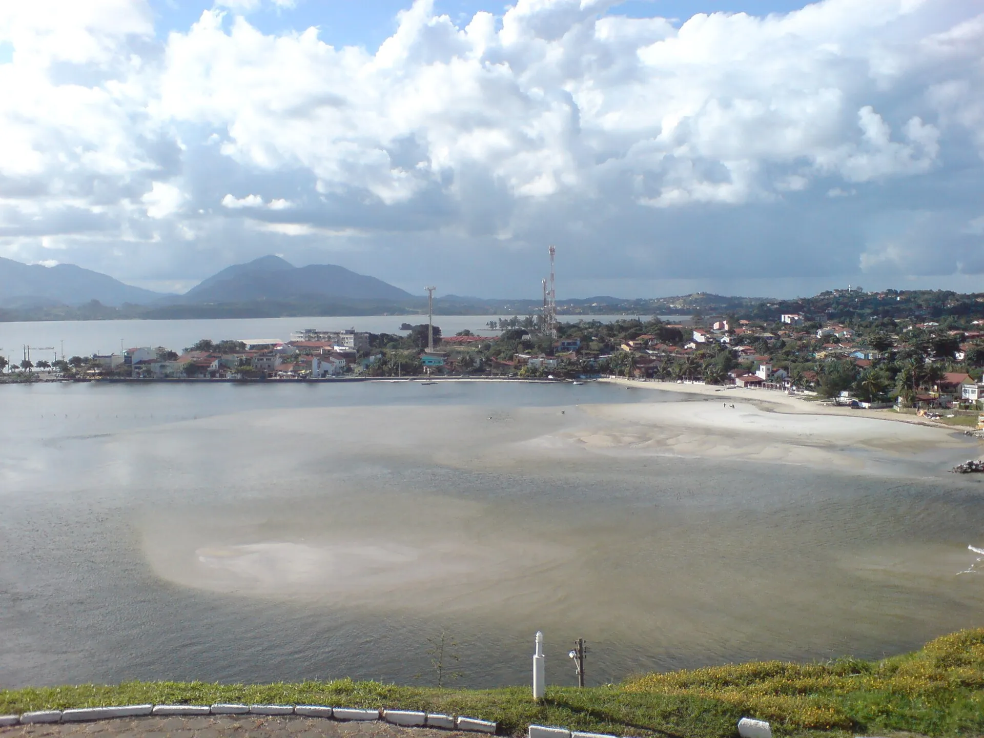 Lagoa de Saquarema com bairros nas margens e serras ao fundo