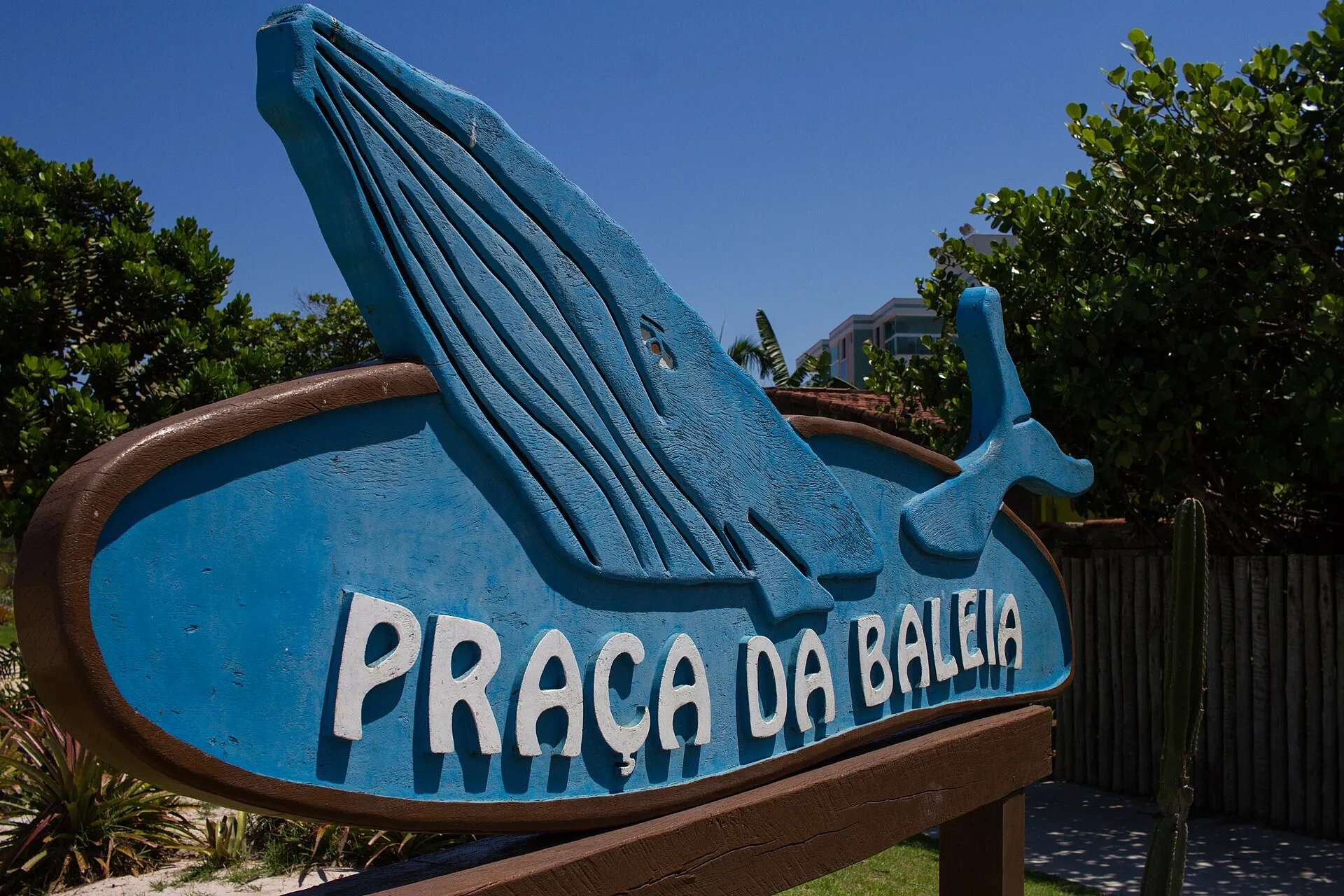 Placa azul em forma de baleia com o nome Praça da Baleia, em Rio das Ostras